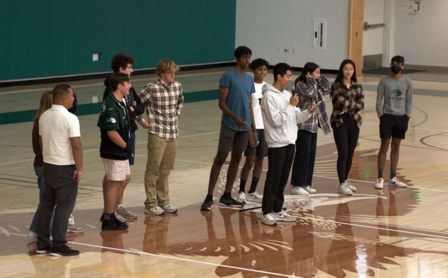 Upper school sports team captains and Coach Alfredo Alves play a game of Guess that Song at yesterdays school meeting. Ryan Jeffers (12) eventually won the contest after several rounds.