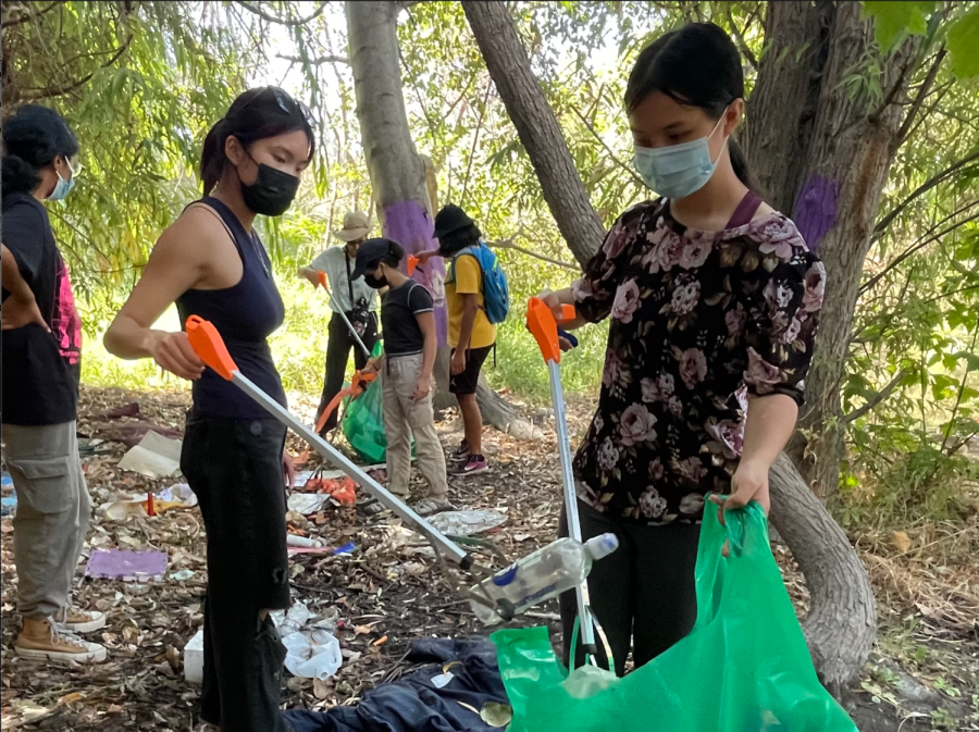 Green Team Public Relations Head Joelle Wang (11) and member Lindsey Tuckey (10) place trash in a bag as possible at a Campbell creek for Coastal Cleanup Day. A total of 18 students participated in the event as part of Californias Coastal Cleanup Day on Sept. 17.