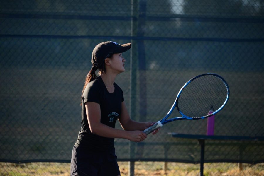 Charlize Wang (10) holds her racket in preparation for the ball. “I was pretty consistent with my backhands, and me and my partner Olivia kept our energy up no matter if we were down or up, and I think that really helped us win today,” Charlize said. 