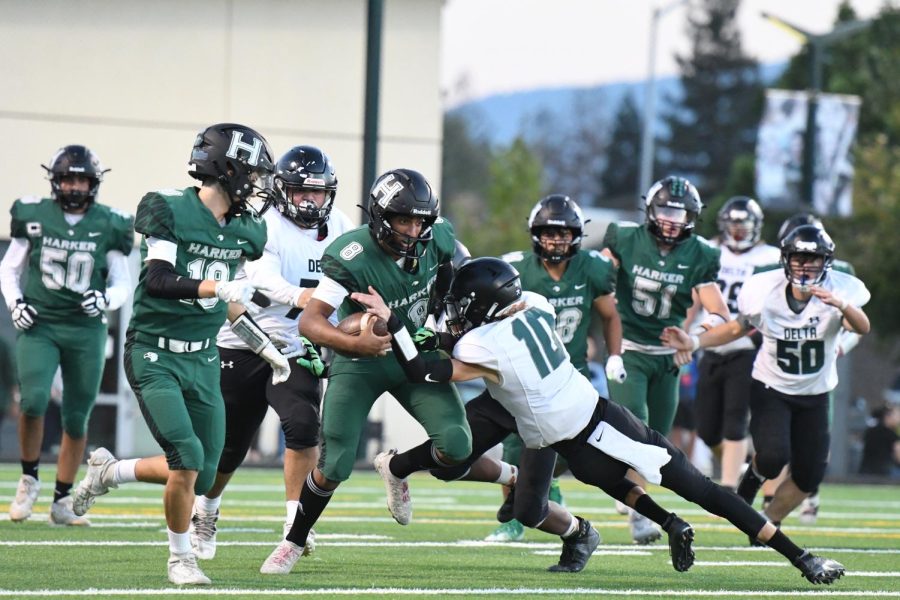 Rohan Gorti (12) rushes past a defender at the varsity football teams Homecoming Game on Saturday. Rohan ran the ball from the left sideline to score the Eagles first touchdown of the night.