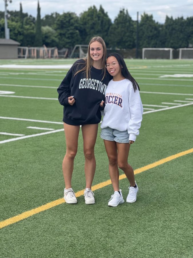 Seniors Emily Novikov and Lexi Wong smile for a photo with their future colleges gear on. Gear is also given to athletes as part of a recruiting incentive.
