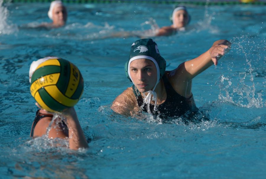 Eyes trained on the ball, Sydney Adler (12) swims towards a Wildcat. Varsity girls water polo fell to Los Gatos 8-13 at home on Sept. 22. 