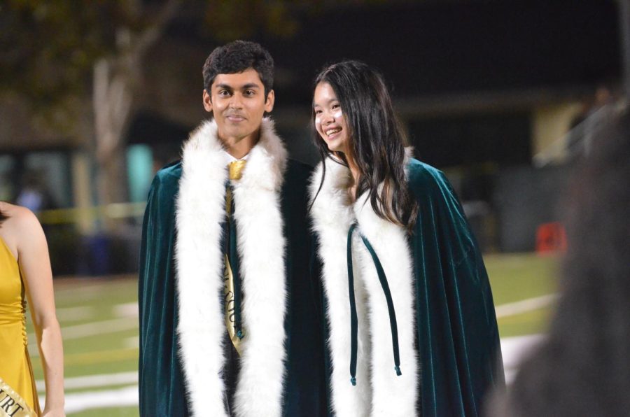 Seniors Sawyer Lai and Atri Banerjee stand on the field after being crowned Homecoming royalty. Senior class dean and Performing Arts Production Manager Brian Larsen delivered the announcement. 