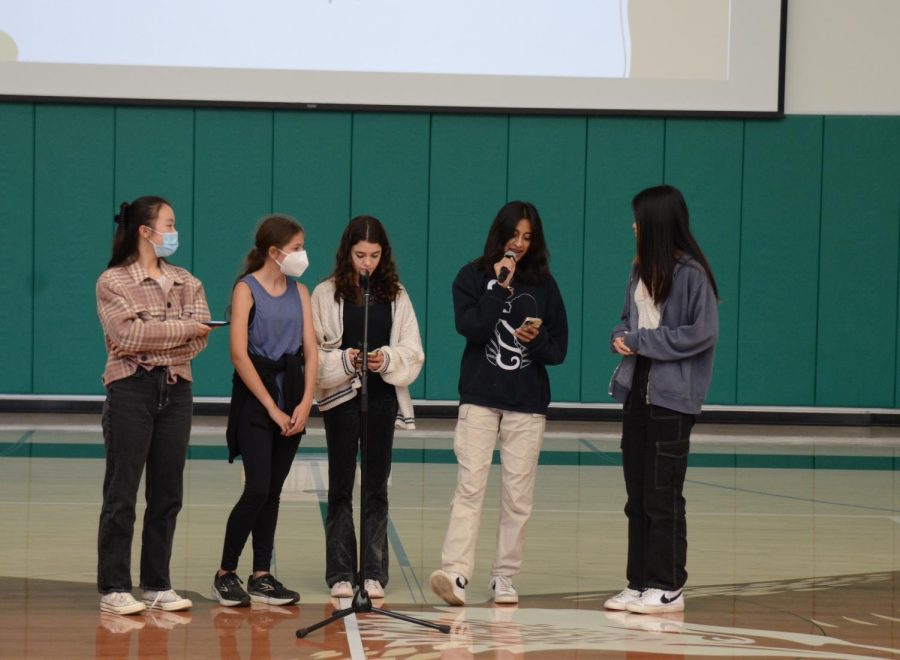 Harker Spirit Leadership Team (HSLT) members speak to upper school students at the school meeting on Oct. 21. They announced the pumpkin carving competition on Oct. 28 during long lunch and invited all students to dress up for Halloween.