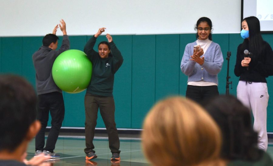 Student Activities Committee members Jacob Huang (12) and Sam Parupudi (10) re-enact last year’s Quadchella yoga ball performance while Amishi Gupta (9) and Ella Lan (11) remind students to attend the second Quadchella. The event took place later that day during lunch.