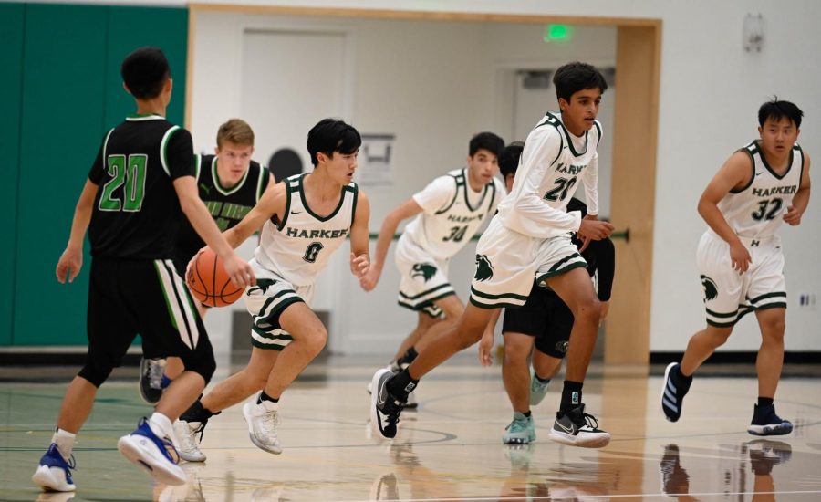 Michael+Chang+%2811%29+drives+the+play+across+the+floor+flanked+by+his+teammates.+Varsity+boys+basketball+kicked+off+their+season+with+a+strong+home+win+over+Yerba+Buena+High+School%2C+scoring+83-28+in+their+first+unofficial+league+game+on+Tuesday.
