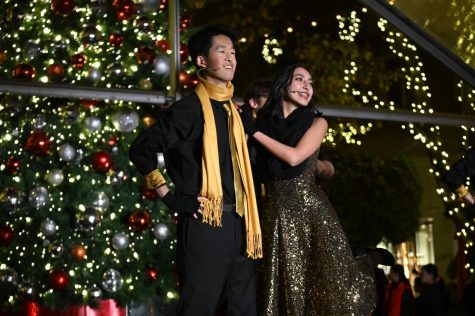Downbeat members Alan Jiang (12) and Shareen Chahal (11) pose as they perform “Deck the Halls.  Upper school groups Harker Dance Company, Kinetic Krew and Downbeat as well as several middle school groups performed at Santana Rows Spirit of the Row on Dec. 6. 