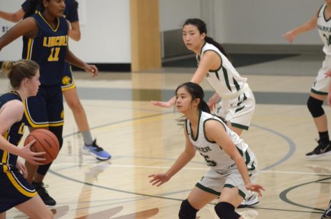Featured photo: Claire Yu (9) and Lexi Nishimura (12) defend a Lincoln High School player at the varsity girls basketball game on Tuesday. The Eagles defeated Lincoln 51-19.