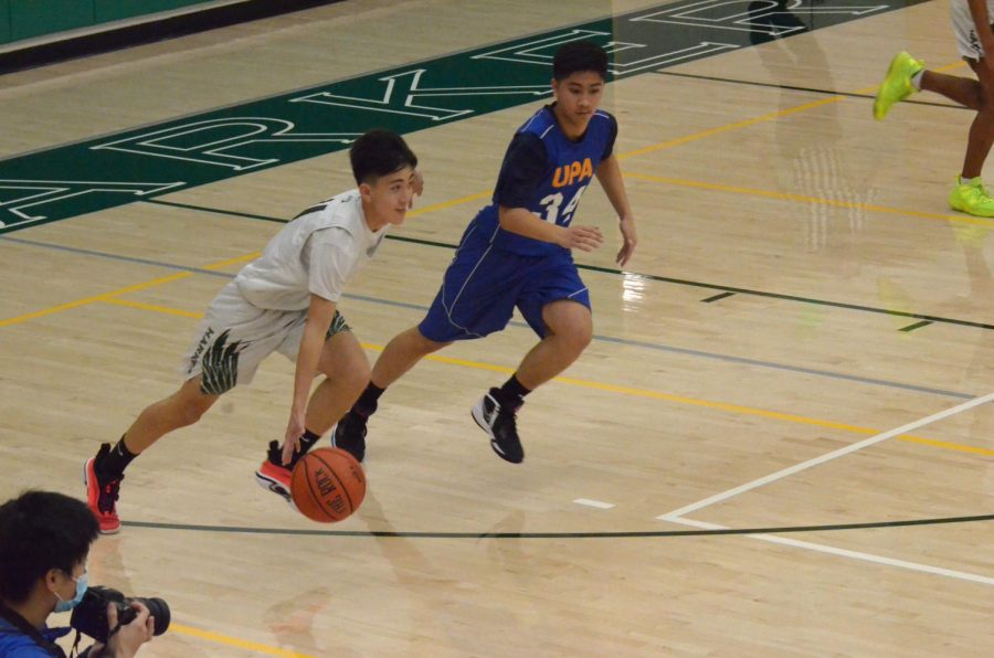 Gary Jin (10) dribbles past a University Prep defender. “[Every practice] we work on the same plays,” Gary said. “We also practice against defense to practice reading [the defense]. Every single day we have to work hard at practice, and that translates into gameplay.”