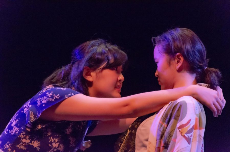 Germaine, a bartender played by Lucy Feng (12), argues with Picasso, Selina Xu (11), in Picasso at the Lapin Agile. This play was directed by Aastha Mangla (12).