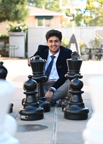 Vyom Vidyarthi (10) sits behind the king and queen chess pieces at the large chessboard behind Dobbins Hall. His current standard rating stands at 2426.