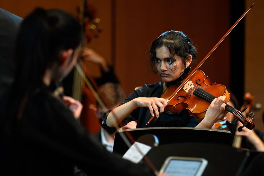 Harshini Chaturvedula (11) plays the viola with Orchestra during the Winter Instrumental Concert. Held on Jan. 13, the concert invited audiences to watch multiple upper school instrumental groups and soloists perform various musical styles, ranging from upbeat Latin jazz to slow ballads. 