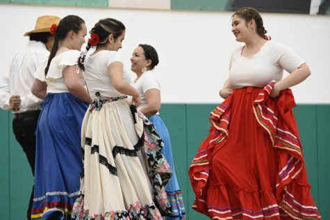 Senior Makayla Aguilar-Zuniga (wearing white skirt) and junior Mariana Ryder (wearing red skirt) face each other during the Latinx Affinity Groups performance of Baile Folklorico for the Cultural Performance Assembly on Feb. 27. Organized by the Student Diversity Coalition (SDC), the Cultural Performance Assembly featured dance, music and poetry from around the world.