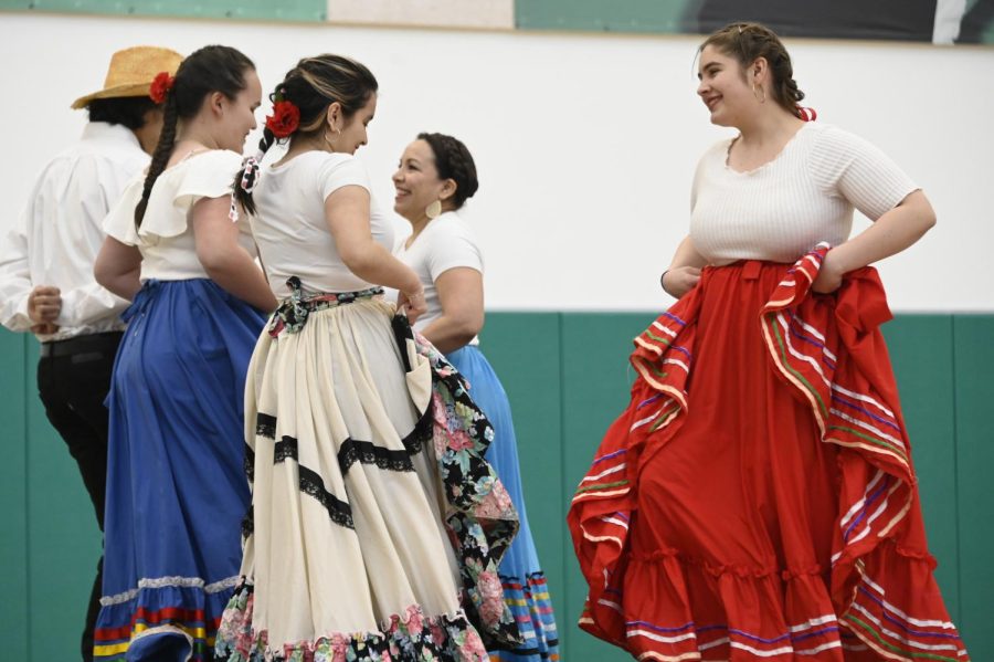 Senior+Makayla+Aguilar-Zuniga+%28wearing+white+skirt%29+and+junior+Mariana+Ryder+%28wearing+red+skirt%29+face+each+other+during+the+Latinx+Affinity+Groups+performance+of+Baile+Folklorico+for+the+Cultural+Performance+Assembly+on+Feb.+27.+Organized+by+the+Student+Diversity+Coalition+%28SDC%29%2C+the+Cultural+Performance+Assembly+featured+dance%2C+music+and+poetry+from+around+the+world.