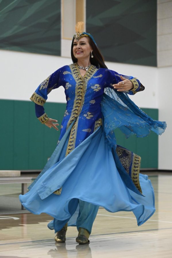 A dancer from Bay Area ensemble Ballet Afsaneh twirls across the gym floor. As the only performers from outside of Harker, Ballet Afsaneh represented the Silk Roads through a combination of Persian dance and storytelling.