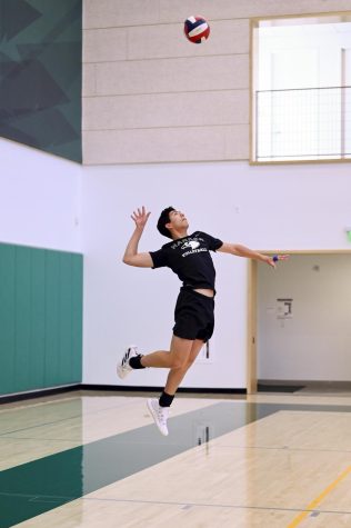 Zachary Blue (11) leaps up for a jump serve during varsity boys volleyball practice on March 6. The boys won their season opener against Menlo Atherton.