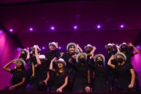 Harmonics poses at the end of Lullaby of Birdland. The middle school show choir performed with white hats, dancing across the stage and weaving through formations.
