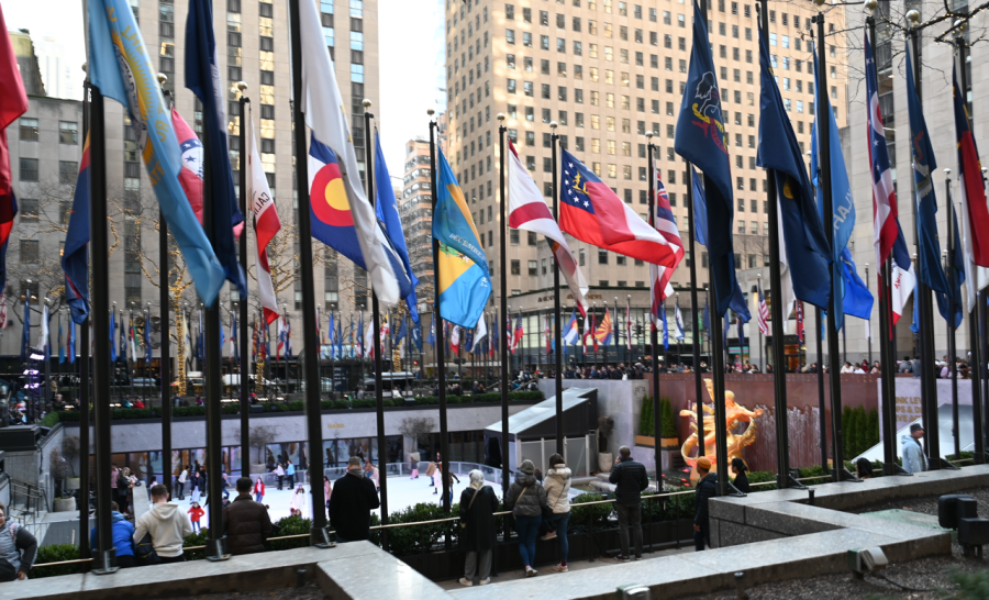 A row of vibrantly colored country flags sway with the wind, above the outdoor skating rink and famous golden statue of Prometheus in New York Citys Rockefeller Center. Upper school journalism staff visited Rockefeller Center on Thursday, exploring its various shops, restaurants and monuments. 