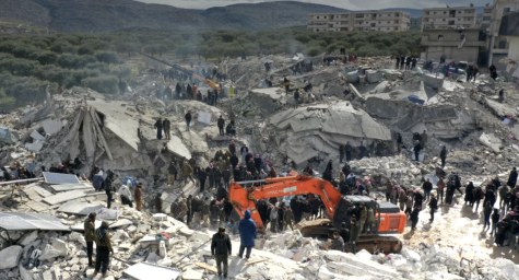 Civilians stand in the wreckage of crumpled buildings in the village of Besnia near the town of Harim, in Syrias rebel-held northwestern Idlib province on the border with Türkiye. A 7.8 magnitude earthquake hit areas of southern Turkey and northern Syria on Feb. 6, resulting in at least 50,000 deaths and leaving hundreds of thousands homeless. 