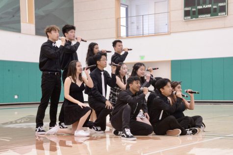 Downbeat performs a set during the school meeting on Monday as a preview of their concert yesterday. The group recently placed fourth at the International Championship of High School A Capella quarter finals, with Dance captain Samvita Gautam (12) winning Best Student Choreographer.