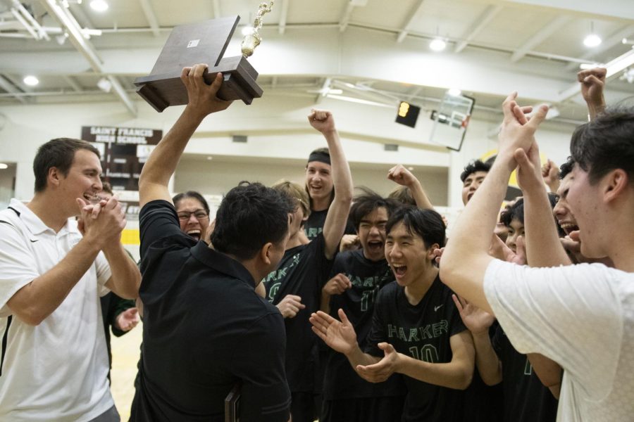 Triumphant, head coach Zachary Mattson holds the trophy of the varsity boys volleyball teams Central Coast Section Division Two victory against Carmel High School on May 13.