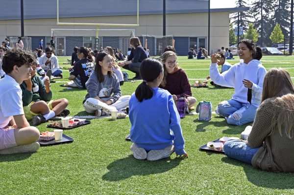 Seniors Matthew Goetting, Fiona Yan, Emily McCartney and Harshini Chaturvedula catch up with their eagle buddies over lunch at Davis Field on Friday. Students talked with their Eagle Buddies before participating in a variety activities.