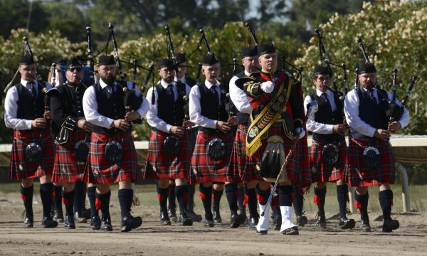 Members of the Winnipeg Police Band of Winnipeg, Canada march before the audience stands prior to their performance. The band is one of the few bands in the world to wear the Royal Stewart tartan, the personal tartan of Queen Elizabeth.