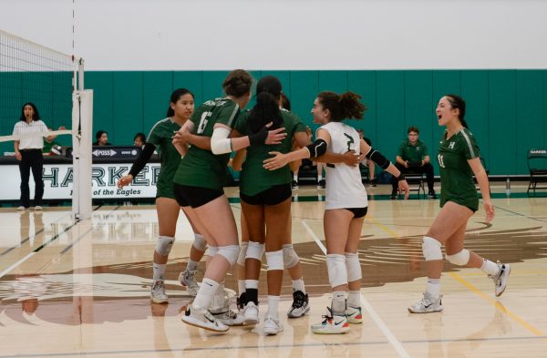 Players congratulate each other on a powerful kill during the first set. The varsity girls volleyball team upset Pinewood 25-15, 25-12, 25-6 in a home game victory on Sept. 12.