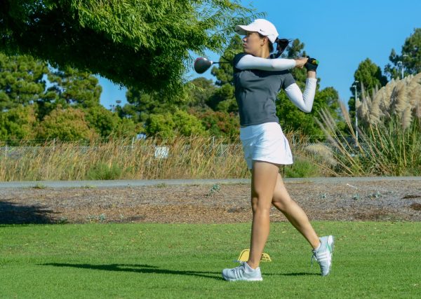 Junior Allison Yang watches her shot after she tees off at the second hole. The girls golf team beat both Mercy High School and Castilleja School in their match.