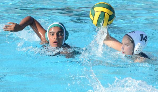 Tvisha Ganesh (9) swims to defend against a St. Francis field player. Tvisha scored a point for her team during the first quarter of the game.