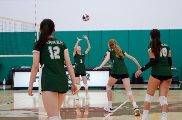 Setter Emma Lee (9) sets the ball to the middle during the match against Pinewood on Sept. 12. “[I’m looking forward to] getting more skilled, learning more about my position and also becoming better friends with all of my teammates, Emma said.