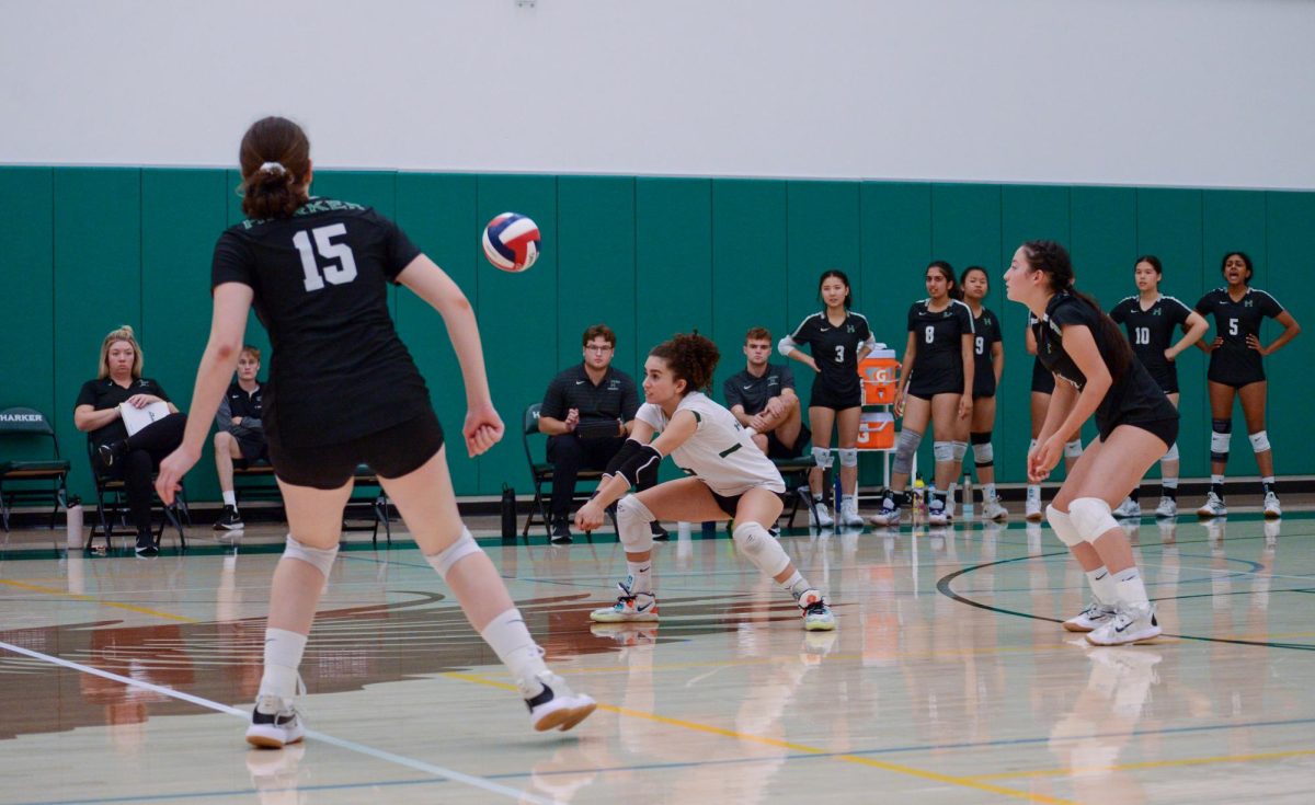 Norah Mehanna (11) prepares to dig a spike by Castilleja. The Varsity girls won the game against Castilleja in three sets.