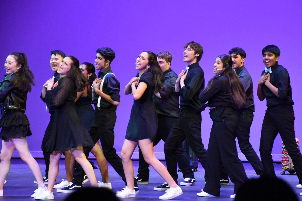 Harkers show choir Downbeat performs in the Patil Theater on Harker Day. Harker Day is really fun because after the performance I can spend time with my friends and have fun, Resham Lamva (7), singer in middle school vocal ensemble Concert Choir, said.