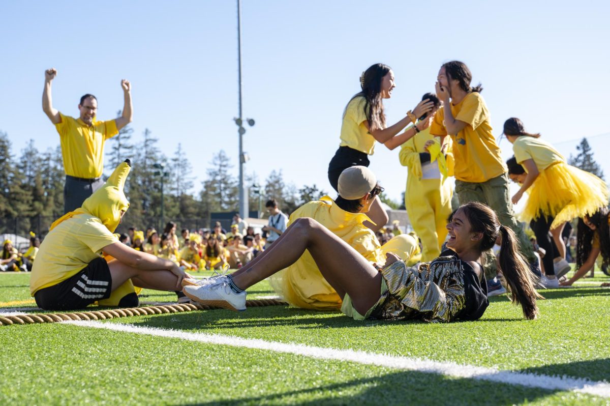 Samaara Patil (9) laughs after falling from the tug-of war-match against the juniors today on Davis Field. The frosh will face off against the sophomores before the Homecoming game on Saturday.