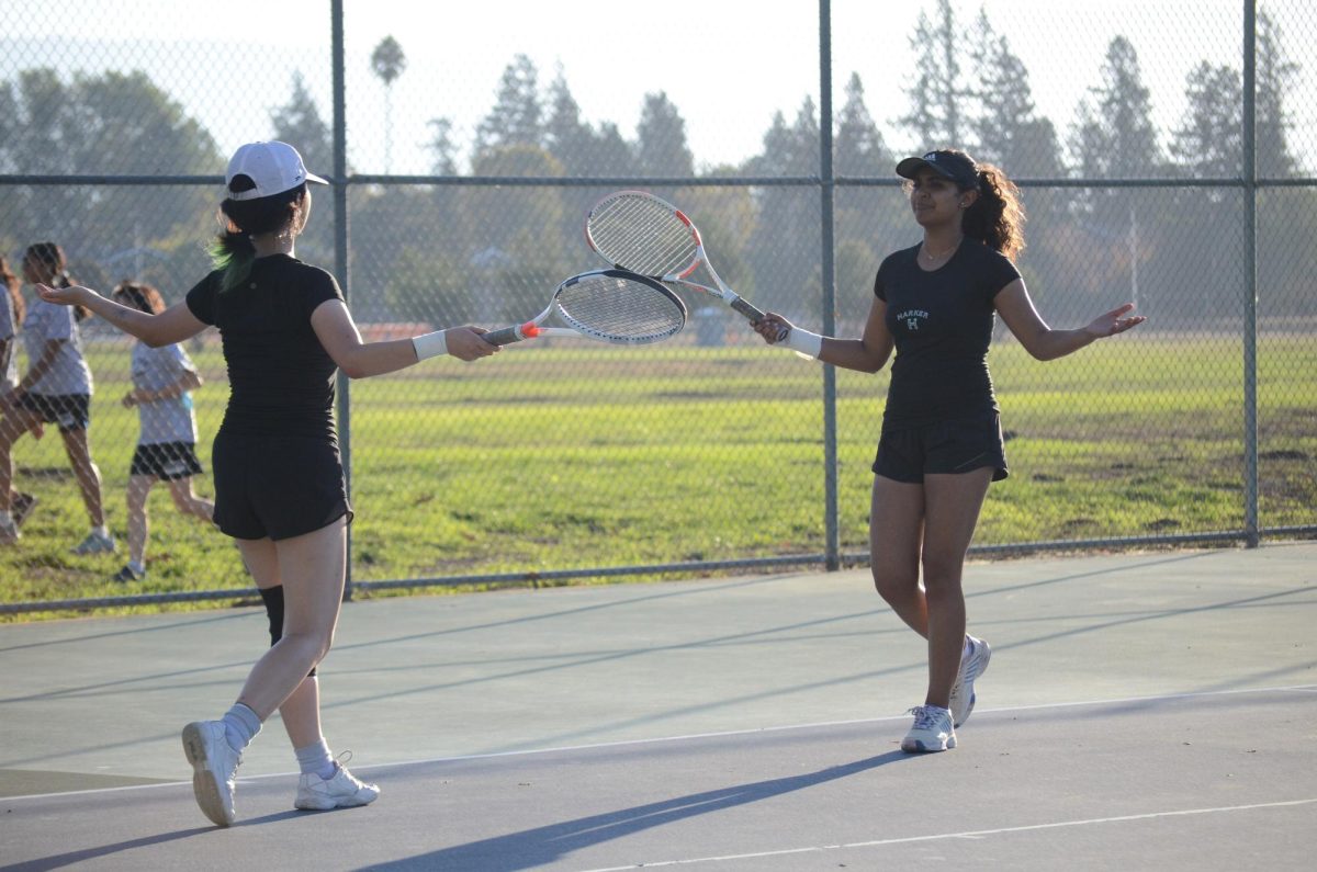 Co-captain Jessica Wang (11) and Anika Akkiraju (10) celebrate after winning a point. The pair fought against Castilleja before their 3-6, 5-7 loss. 