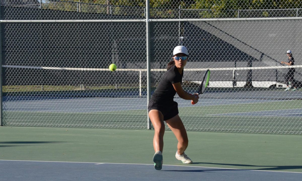 Claire Xu (9) hits the ball during pre-game practice. Claire won both her sets 6-1 and 6-2 in the match versus Castilleja.