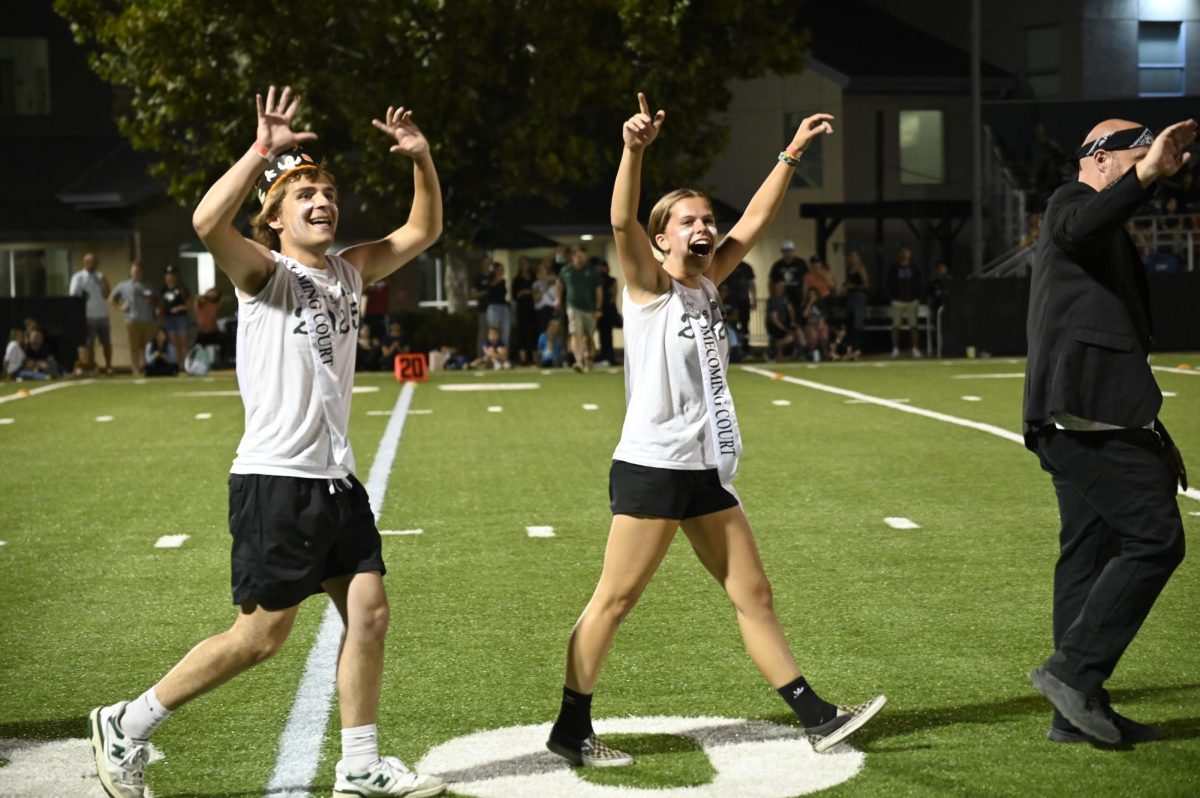 Junior Homecoming Court Picks Leo Sobzycn and Claire Anderson cheer during the Homecoming Royalty Presentation. Members are elected by their class each year. 