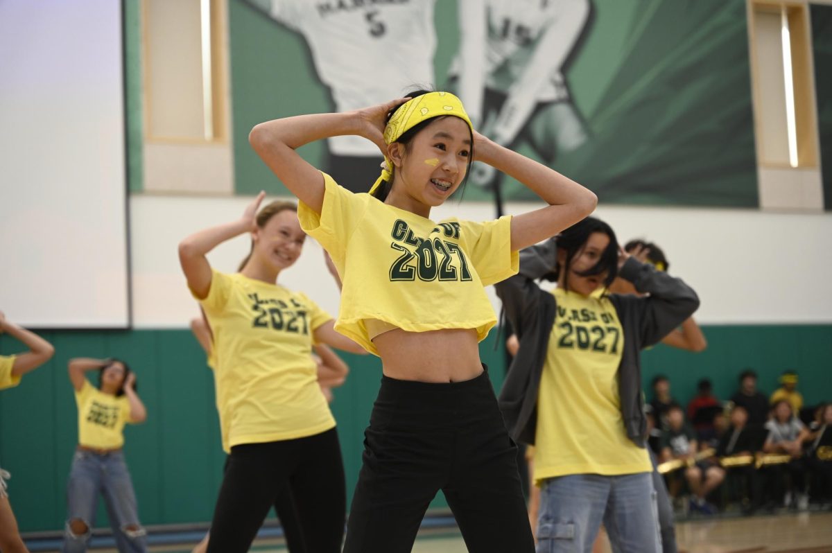 Chelsea Xie (9) dances during the froshs Mamma Mia lip sync in the spirit rally. “We really owe it to the leaders of this grade for the lip sync,” frosh lip sync and cheer performer Jessica Chen (9) said. “They spent a really long time putting it together.