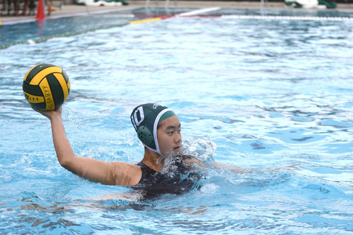 Melody Yin (11) holds the ball in preparation to pass to a teammate. The team worked on moving the ball to the left side of the pool during practice.