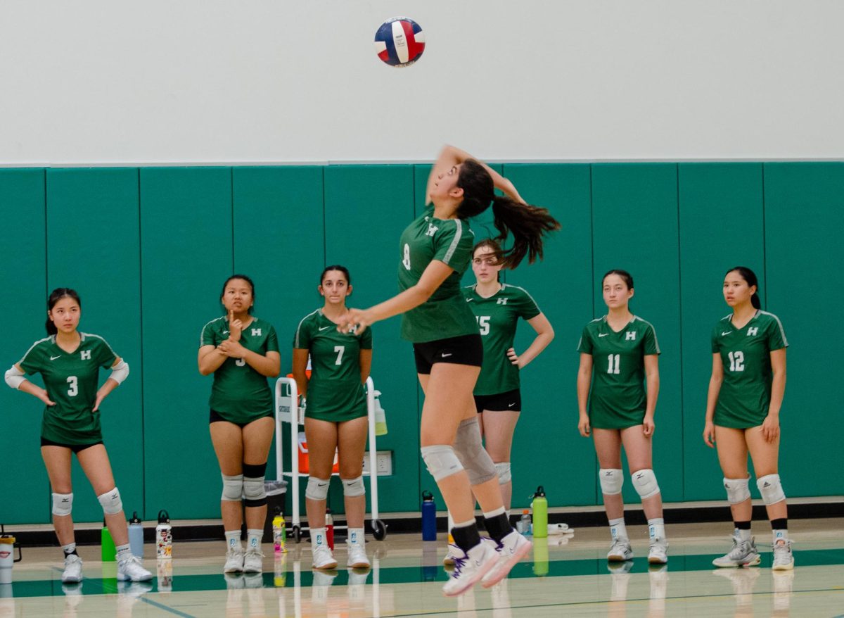 Navya Samuel (11) leaps into the air to serve. The Eagles lost to Crystal Springs in a three set match on Sept. 21.