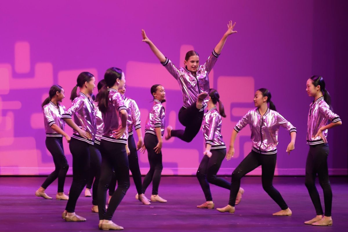 A middle school member of Showstoppers leaps during their dance at the Harker Day production on Oct. 7. Showstoppers represented Japan in the show. 