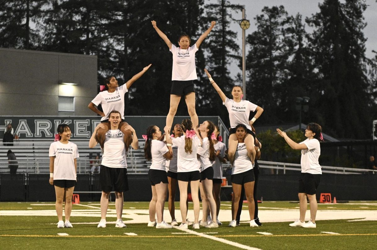 The cheerleading team assembles a formation during Harker’s football home opener. This year’s team features 15 members.