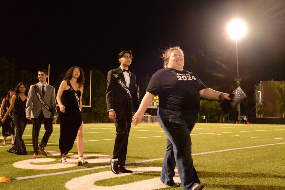 Senior Class dean Carol Green leads the senior homecoming court across the field.  There are six nominees among the class of 2024.