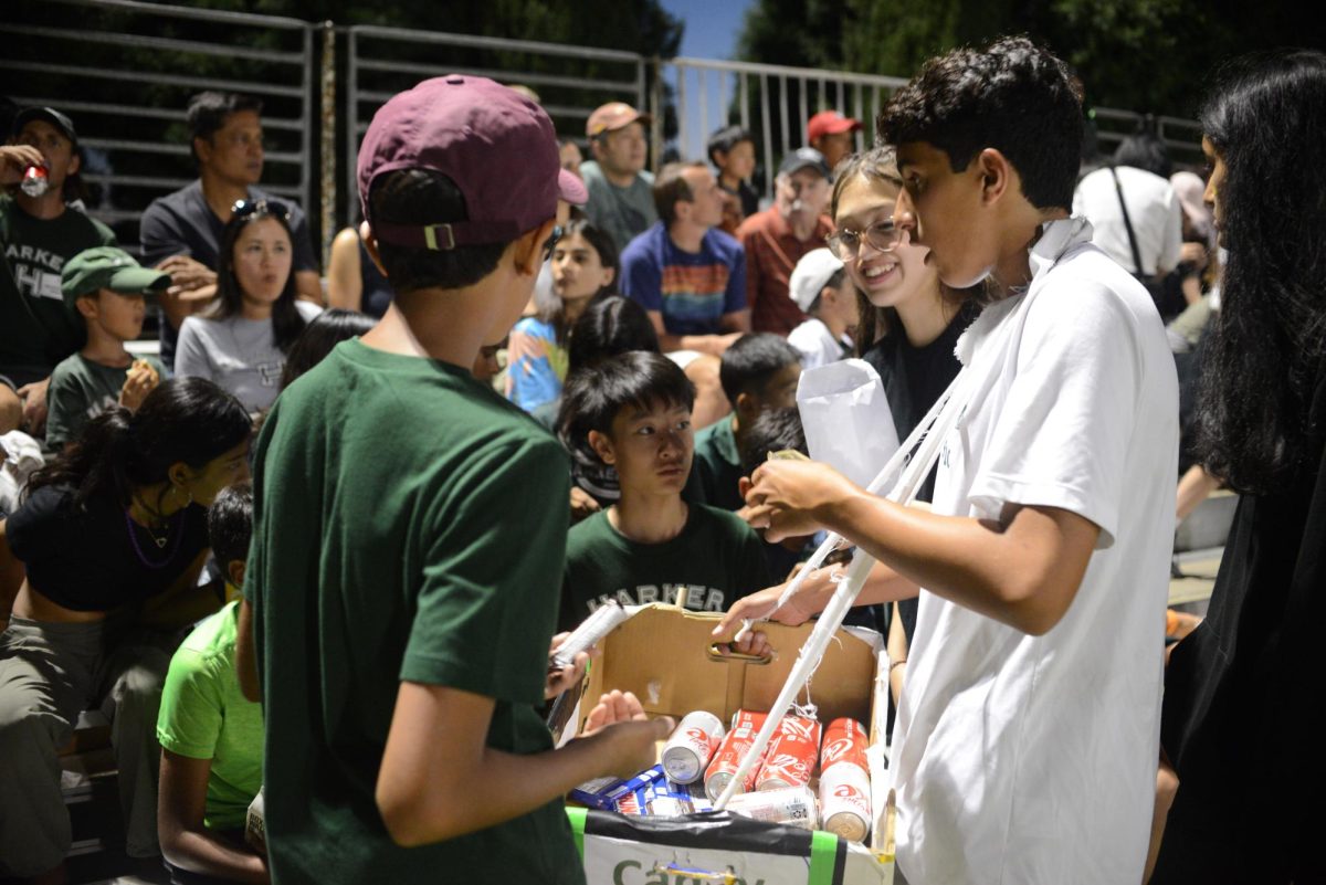 Akash Dubey (9) sells candy to game attendees. All frosh advisories staffed concessions stands over the course of the night.