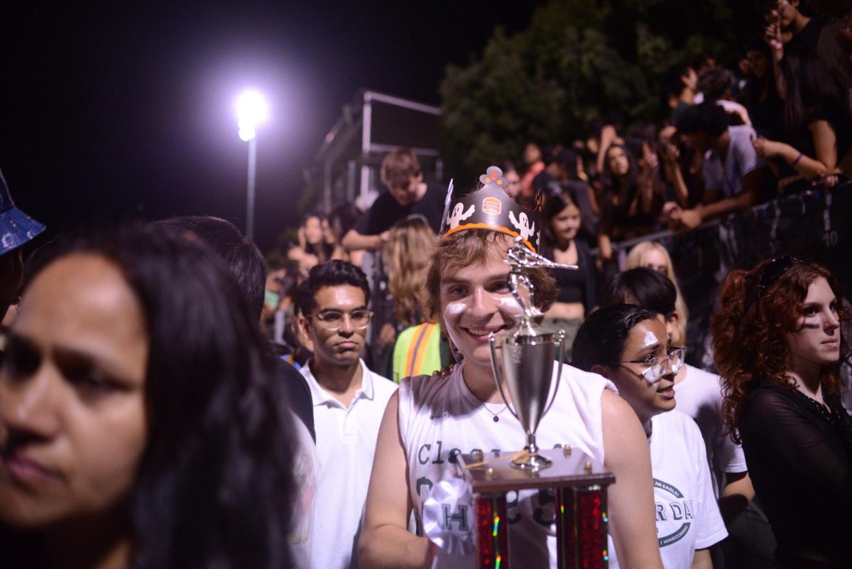 Leo Sobczyn (11) smiles as they hold the tug-of-war trophy. The juniors defeated the seniors in the halftime tug-of-war contest.