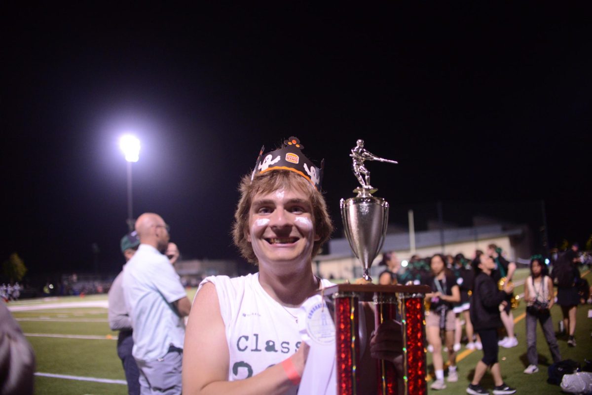 Leo Sobczyn (11) smiles as he holds the tug-of-war trophy. The juniors defeated the seniors in the halftime tug-of-war contest