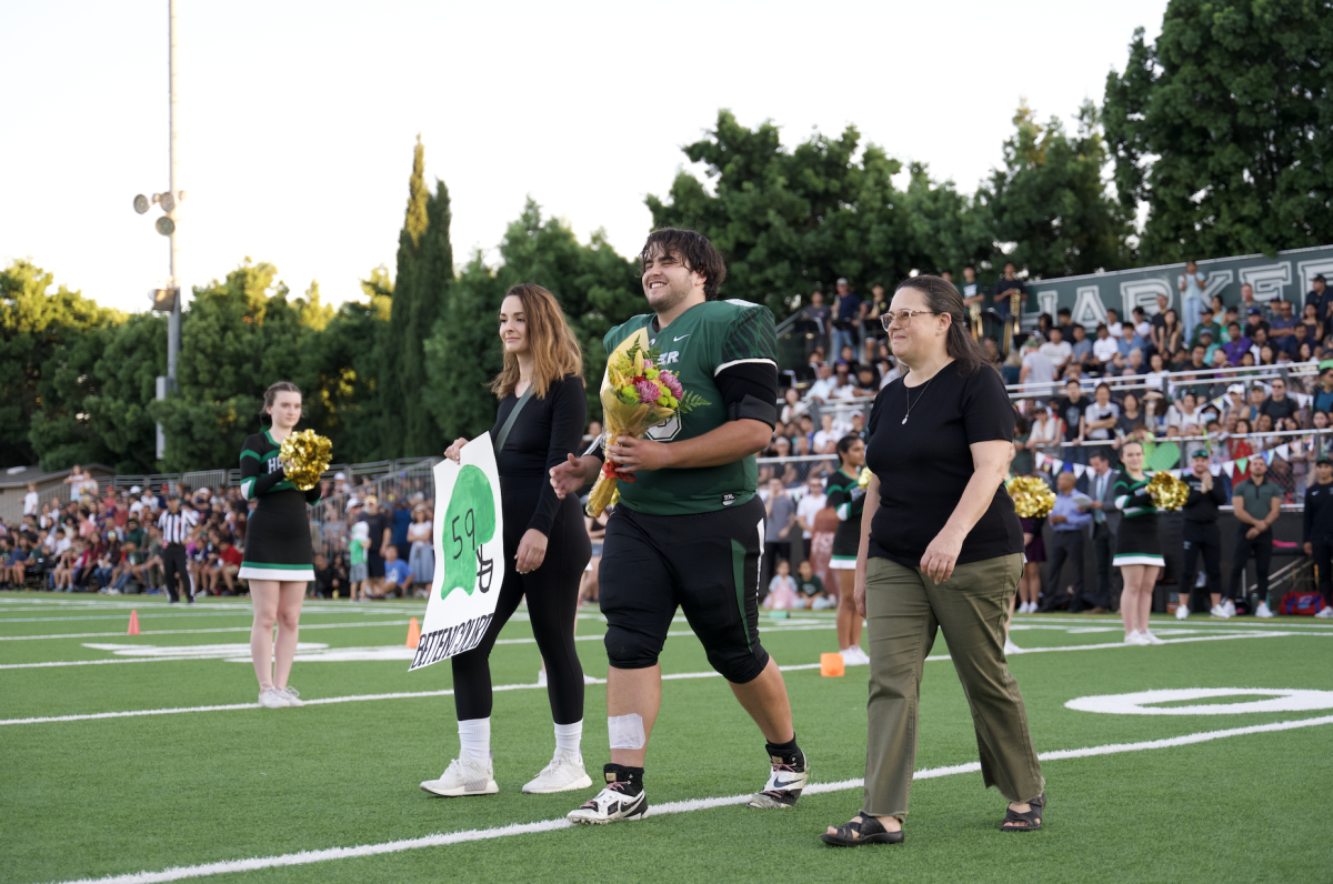 Kevin Bettencourt (12) walks across the field during the senior night celebration. Harker senior football players participated in the ceremony with their parents.