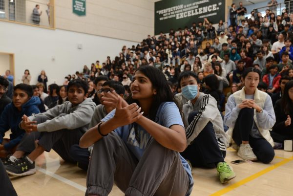 Riya Samuel (9) claps for the frosh class as they participate in a family feud competition. The senior class came out on top, followed by the sophomores, juniors and the frosh.