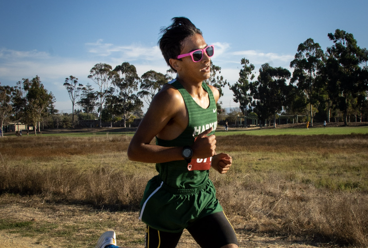 Veyd Patil pushes during a cross-country race. He often dons unorthodox gear, like his pink sunglasses. 