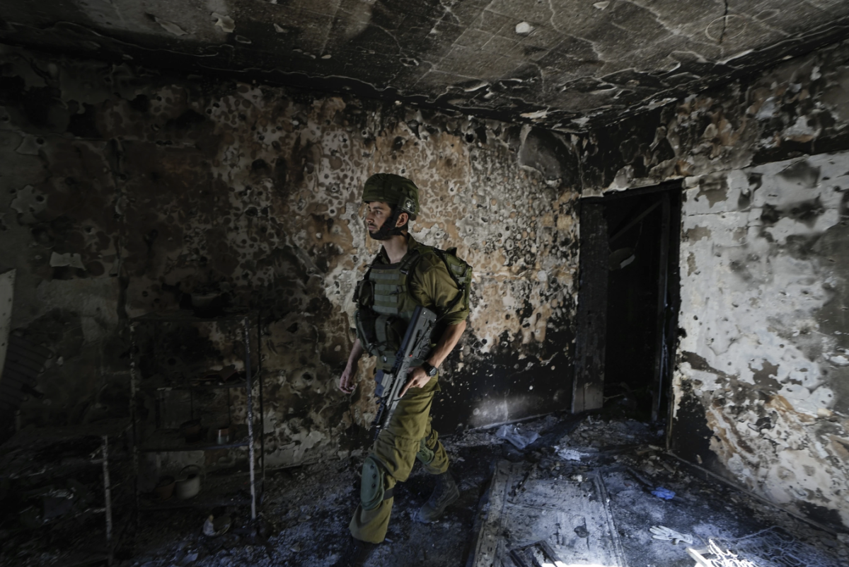 An Israeli soldier examines a damaged house in Israel on Oct. 18. The attack by Hamas occurred on Oct. 7, when militants from the nearby Gaza Strip killed and captured numerous Israelis. (Provided by AP News)